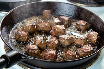 Searing meats is a great use for your cast iron skillet.